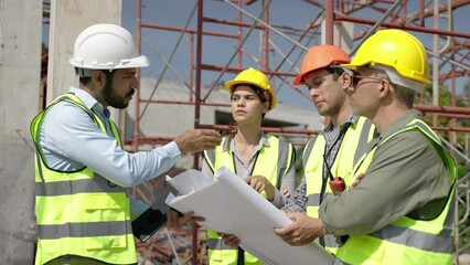 team engineers are surveying to supervise the work in accordance with the construction plan at the construction site
