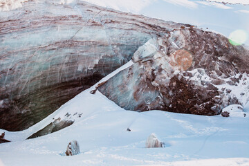 Beautiful ice cave in glacier. Winter mountain landscape.