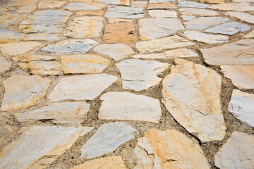 Old italian paving built with irregularly shaped stone blocks called opus incertum