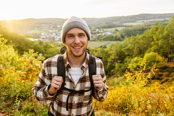 Joyful man tourist standing at forest glade during hiking © Drobot Dean