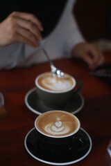 Fototapeta na wymiar latte art on the wood table in the coffee shop