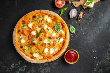 four cheese pizza, homemade italian pizza. Pizza on rustic black background. Traditional italian cuisine. place for text, top view