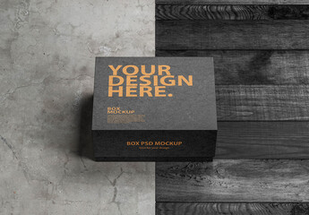 Black square box mockup packaging on the concrete floor