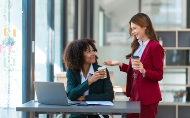 Young trader mixed race woman in formal suit friends consulting and discussing with stock market and cryptocurrency in online trading application.