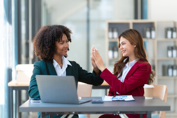 Young trader mixed race woman in formal suit friends consulting and discussing with stock market and cryptocurrency in online trading application.