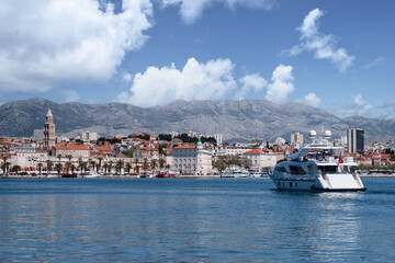 Fototapeta na wymiar Travel by Croatia. Beautiful landscape with Split Old Town on sea promenade. Yacht in the harbour.