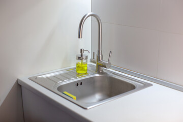 Sink Reflections in the kitchen in white color. Modern style. 