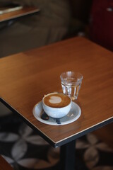 latte art on the wood table in the coffee shop
