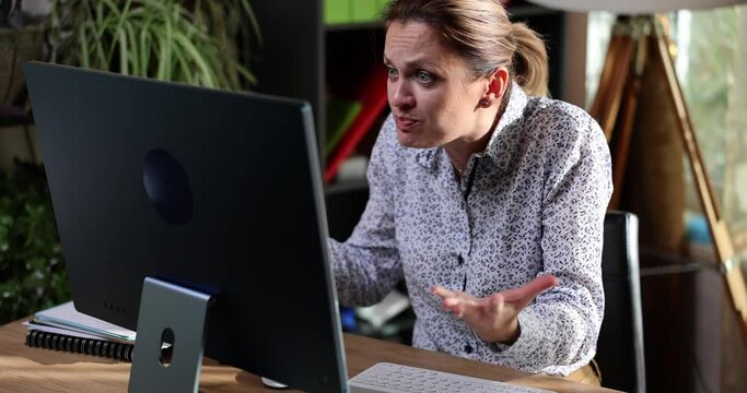 Portrait of angry business woman with frustrated look working on computer in office