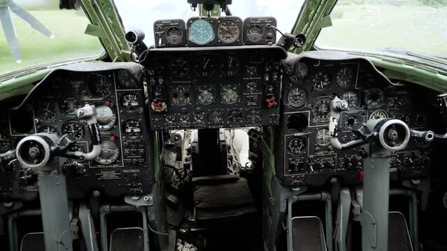 Control panel in cabin of old aircraft with command texts in russian language: latitude, altitude, stop, attention. Pilots' seats and indicators. Military aeroplane. No logo and trademarks
