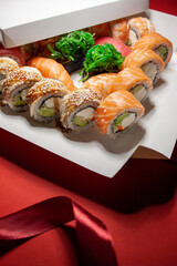 salmon tuna chuka shrimp eel sushi rolls set with red ribbon