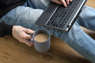 cup with coffee in hand against the background of a person