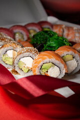 salmon tuna chuka shrimp eel sushi rolls set with red ribbon