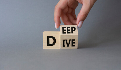 Deep Dive symbol. Businessman hand. Concept words deep dive on wooden cubes. Beautiful grey background. Business and Deep Dive concept. Copy space