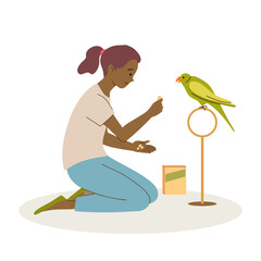 Girl feeds her parrot and spends time with bird. Pet care concept.