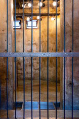 Prisoner steel cage, Prison cell with jail iron bars for criminals, Old prison with bars locked up