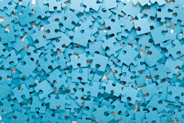 Different many blue puzzle pieces background. Closeup. Top down view.