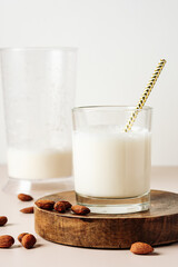 Almond milk in a glass with a straw.