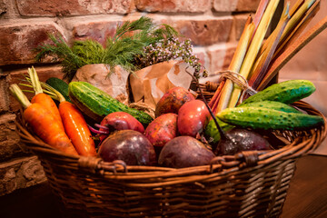 Basket of vegetables, radish, garlic, celery, rhubarb, thyme, mint, sorrel, dill, oregano on a board. Still life on a table of vegetables, herbs and spices. The vegetable garden 