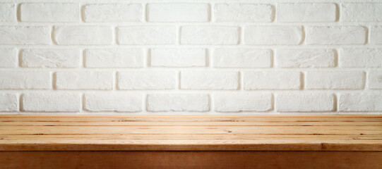 Empty wooden table over white brick wall  background. Interior for mock up design and product display