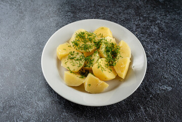 Potatoes with dill on a white plate