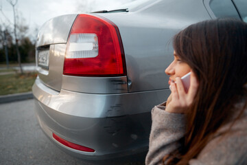 woman stand near scratched auto. call for help. car insurance.