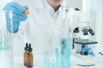 Fototapeta premium Scientist analyze biochemical samples in advanced scientific laboratory. Medical professional use dropper mix microbiological developmental of viral. Biotechnology research in science lab. cosmetic