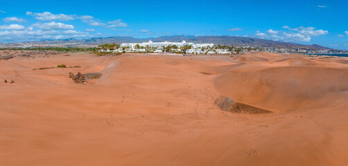 Panoramic aerial scene of the Maspalomas Dunes in Playa del Ingles, Maspalomas, Gran Canaria, Spain. Endless desert sands. Magical safari dunes.