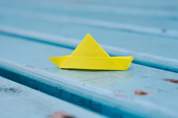 origami paper sailboat sailing on blue water, origami boat sailing in blue ocean , paper art style