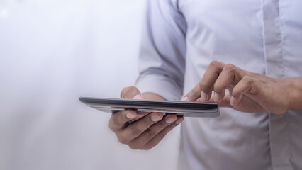 Business man using laptop on blurred background