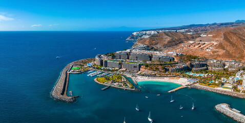 Beautiful aerial landscape with Anfi beach and resort, Gran Canaria, Spain. Luxury hotels, turquoise water, sandy beaches in Spain. Luxury beach vacation concept. Heart shaped island.