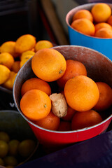 buckets with ripe lemons and oranges at the summer market