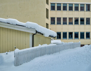 old office building with glass and snow