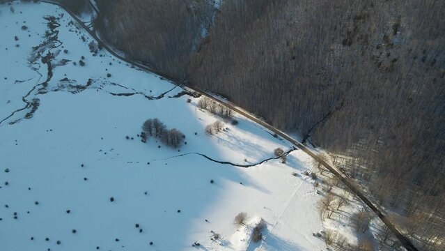 Aerial view of Verteglia Plateau with snow in wintertime at sunset on Mount Terminio, Serino, Avellino, Irpinia, Campania, Italy.