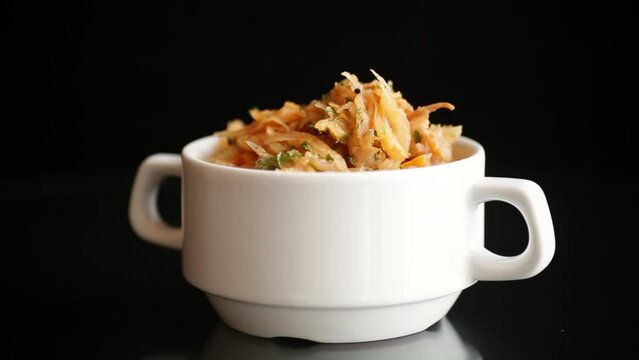 stewed cabbage with carrots and spices in a bowl