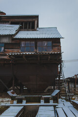 Grain elevator.Old retro grain elevator.Ancient interesting building.Old building.Unusual architecture.Ukrainian village.Grain storage place.Winter landscape.Sad mood.Old windows.Old farm.Tall barn.