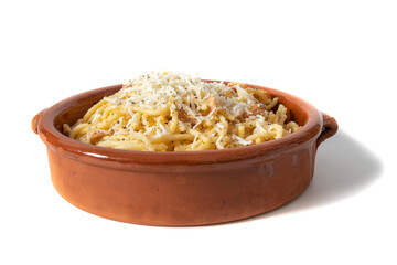Spaghetti carbonara with grated cheese, served in a clay bowl. Isolated on white background. Italian food concept.