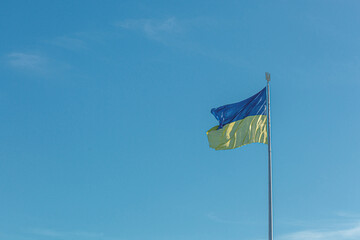 Ukrainian flag against the blue sky
