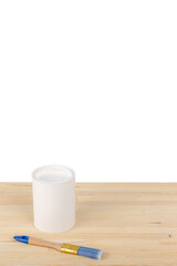 white paint with a brush on a wooden background with texture