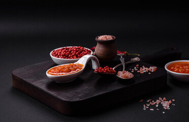 Red adjika sauce or ketchup with spices and herbs