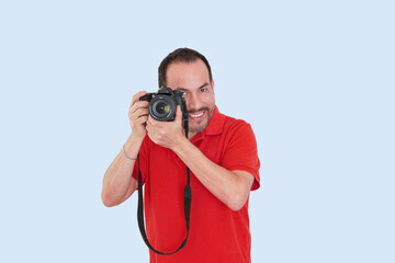Obraz premium fotógrafo latino mexicano con camisa roja sonriente en fondo azul claro 