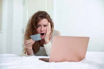Internet fraud. Nervous sad upset unhappy confused young woman, stressed worried lady having...
