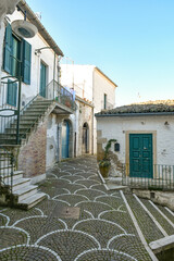 A narrow street between the old houses of Bovino, an ancient town in Puglia, Italy.