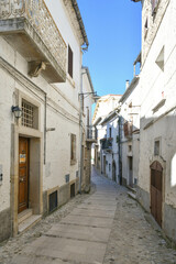 A narrow street between the old houses of Bovino, an ancient town in Puglia, Italy.
