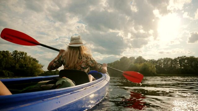 woman paddling kayak on lake during summer
