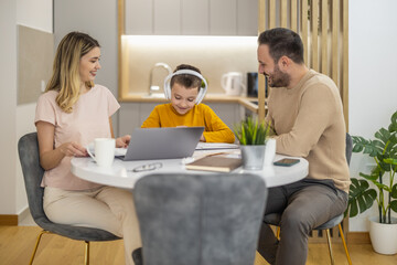 Little boy watching lesson online and studying from home