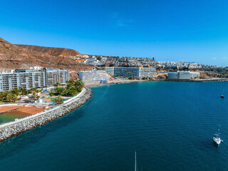 Fototapeta premium Beautiful aerial landscape with Anfi beach and resort, Gran Canaria, Spain. Luxury hotels, turquoise water, sandy beaches in Spain. Luxury beach vacation concept. Heart shaped island.