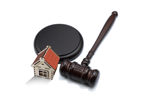 Abstract photo with wooden gavel and abstract house isolated on white background