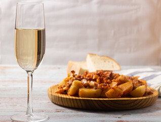 Galician style octopus duck with a glass of white sherry wine. Traditional Spanish food. Mediterranean Cuisine.