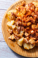 .Close-up of Galician style octopus on its traditional wooden plate. Traditional Spanish food. Mediterranean Cuisine.